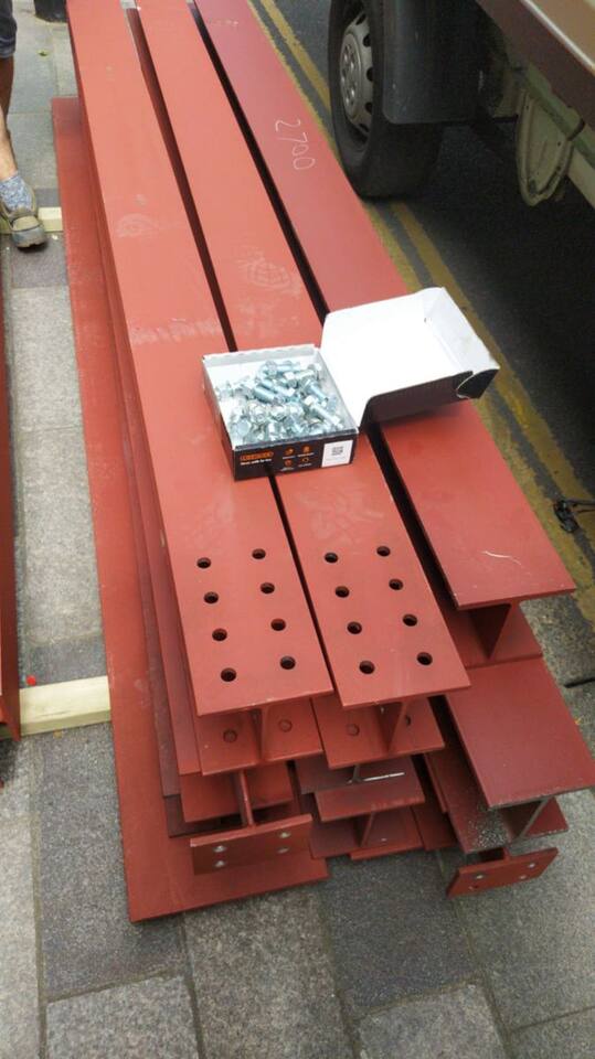 Drilled beams and their bolts, ready for site